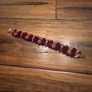 Costume Jewelry bracelet. Red beads set with diamond-like accents. Gold clasp.